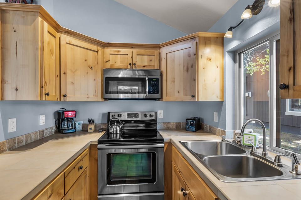 Your fully equipped kitchen features warm wood cabinetry, modern stainless appliances, and everything you need to prepare your favorite meals during your stay.