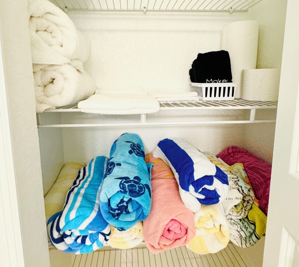 Additional towels and beach towels are stored in the bathroom closet