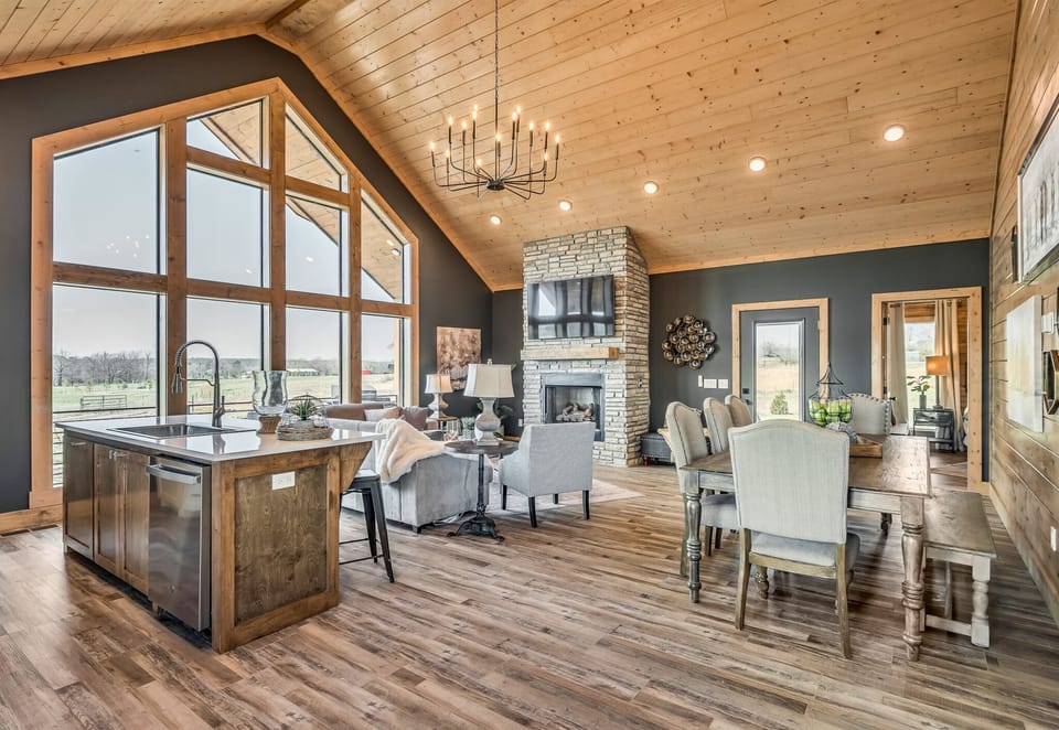 Dine with a view! This beautiful dining area, with its large windows and rustic chandelier, makes every meal a memorable experience.