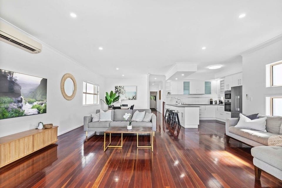 Open-plan living area with air-conditioning, TV and opens to upstairs deck.