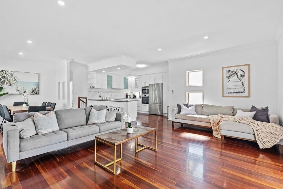 Open-plan living area with air-conditioning, TV and opens to upstairs deck.