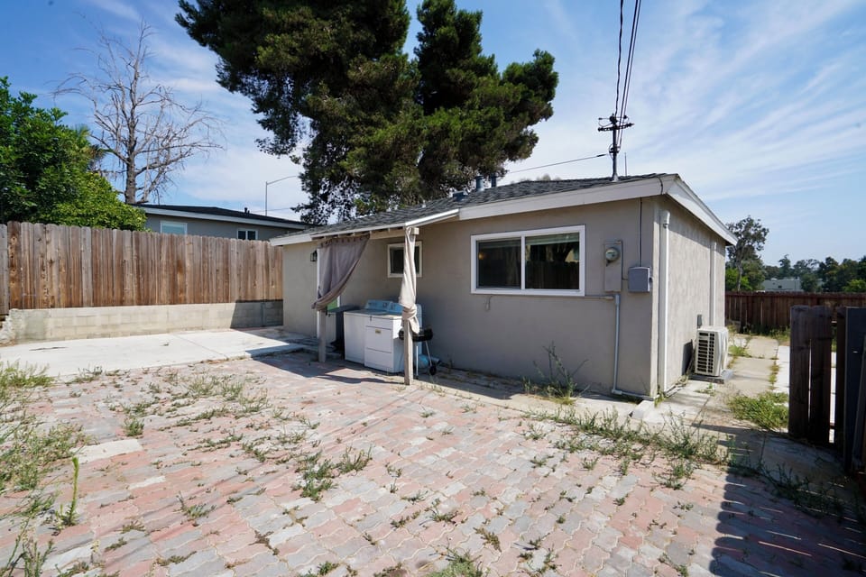 Back Yard big enough to comfortably park two (2) cars