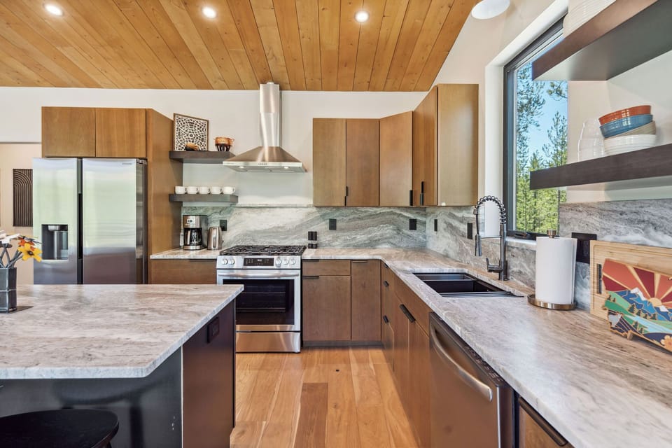 The kitchen has all the top-of-the-line amenities with a dishwasher, microwave, oven, stove, coffee-maker, tea kettle, refrigerator and freezer with a water filter, a large island and countertop seating, cutting boards, cutlery, and more. Everything you'll need is right at your fingertips. 