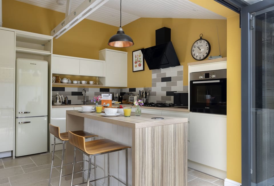 Bi-folding doors extend the kitchen into the pretty courtyard outside