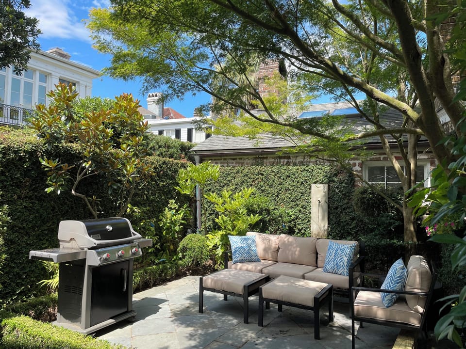 Private outdoor patio with fountain and gas grill