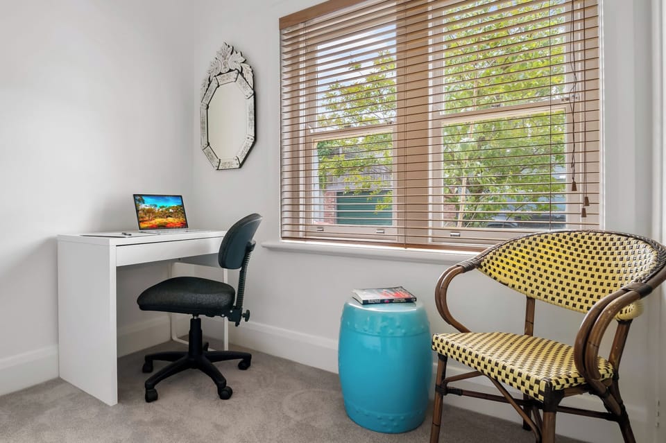 APARTMENT 2 FRONT BEDROOM: The front bedroom has a desk with street outlook that’s perfect for working from home.