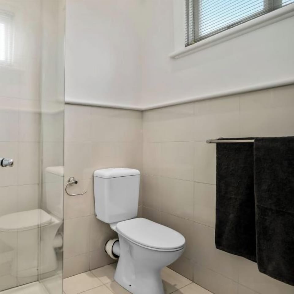 BATHROOM: The bright bathroom has a shower and laundry with washer/dryer. 