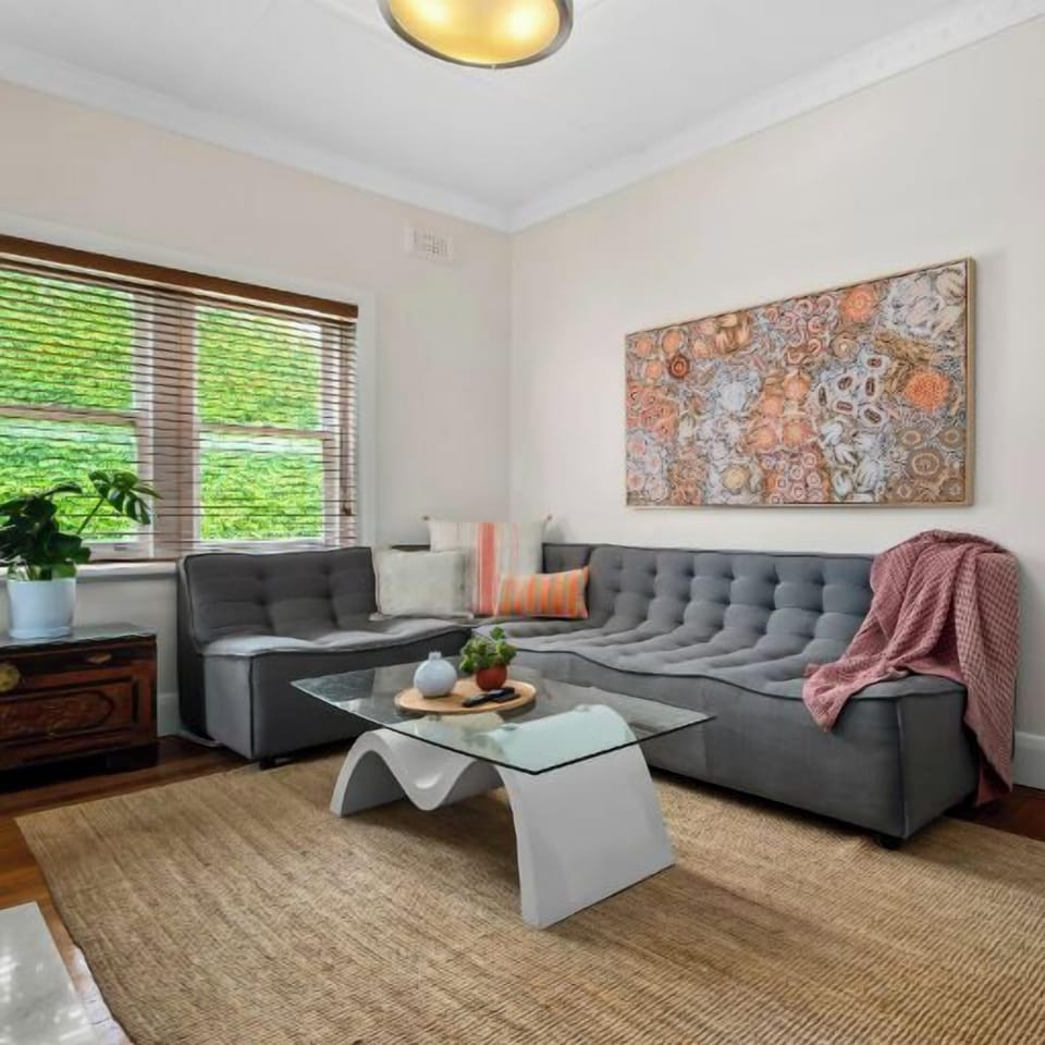 LOUNGE: The sunny, spacious,  separate Lounge Room has original Art Deco features collected furniture and artwork. The Lounge has a large screen Smart TV and Bluetooth Home Theatre sound system.