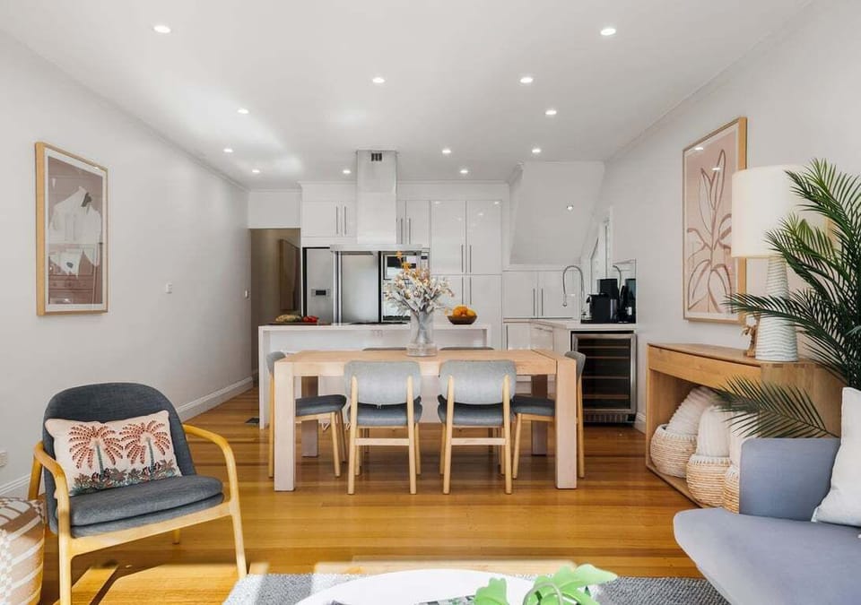 DINING: Stylish dining and kitchen space with a warm modern atmosphere.