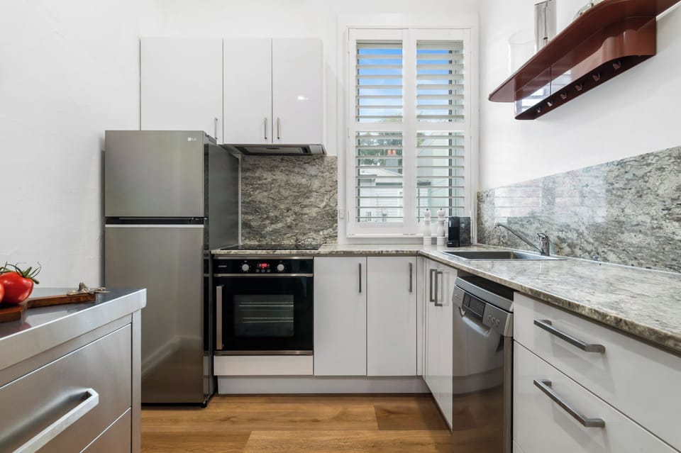KITCHEN: The stylish kitchen with stone bench top has all the needed appliances for cooking pleasure. 