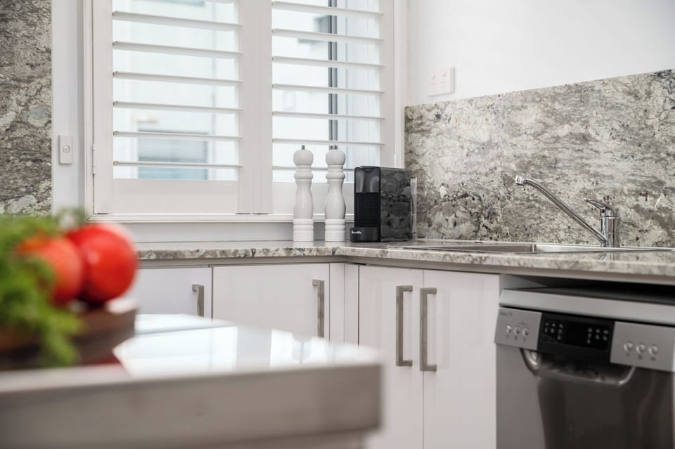 KITCHEN: The kitchen has a sunny window outlook, dishwasher, Nespresso Coffee Machine and a conveniently  stocked pantry. 