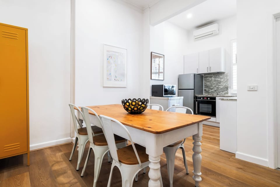 DINING ROOM: The dining room has a large table that comfortably seat six is located conveniently adjacent to the kitchen. 