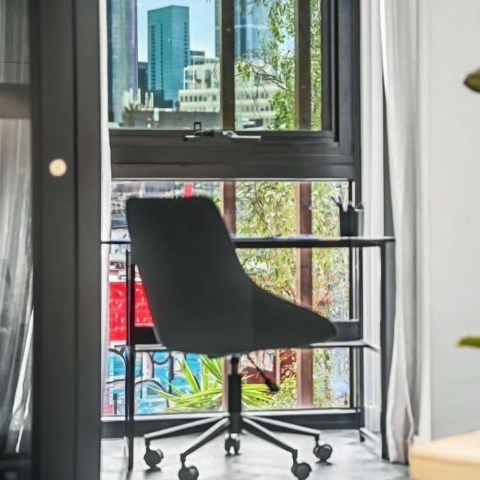 DESK: A desk is provided for work from home convenience with a stunning cityscape outlook. 