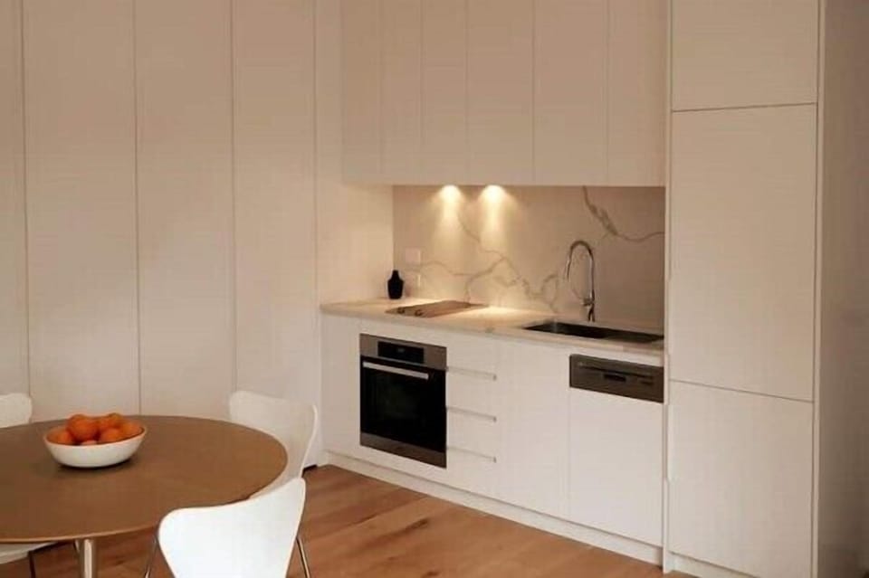 KITCHEN: Stone bench tops. Integrated Miele appliances. Induction cook top. Integrated fridge. Concealed pantry. Concealed laundry.