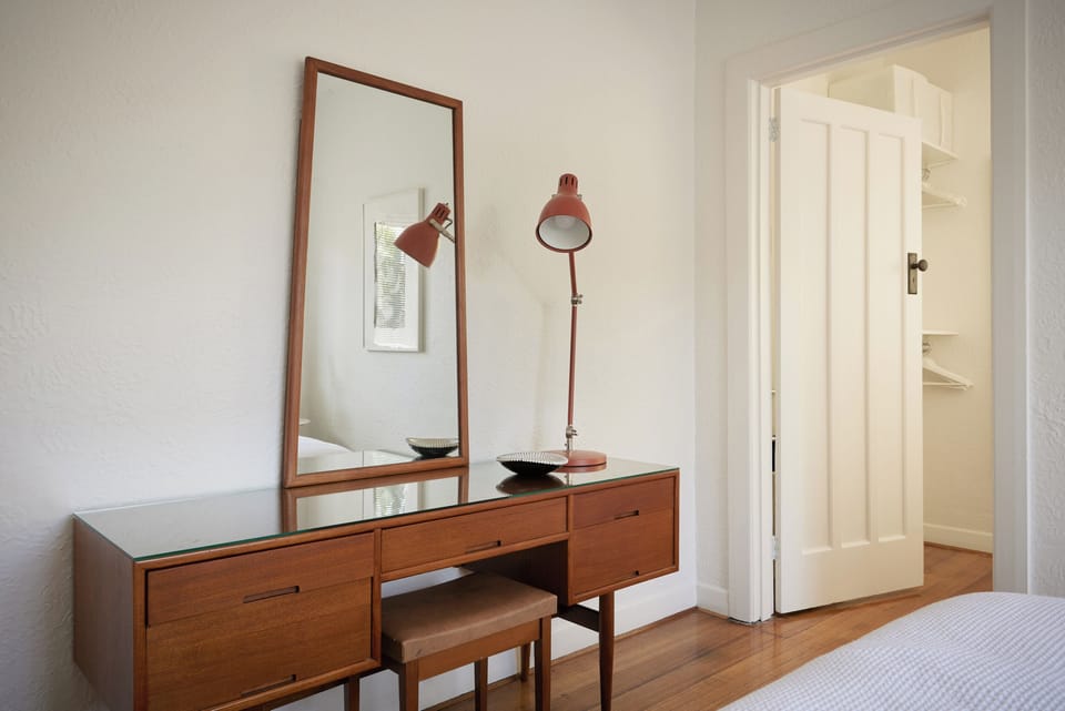 BEDROOM 2: The bedroom has a convenient vanity unit that can be used as a desk. 