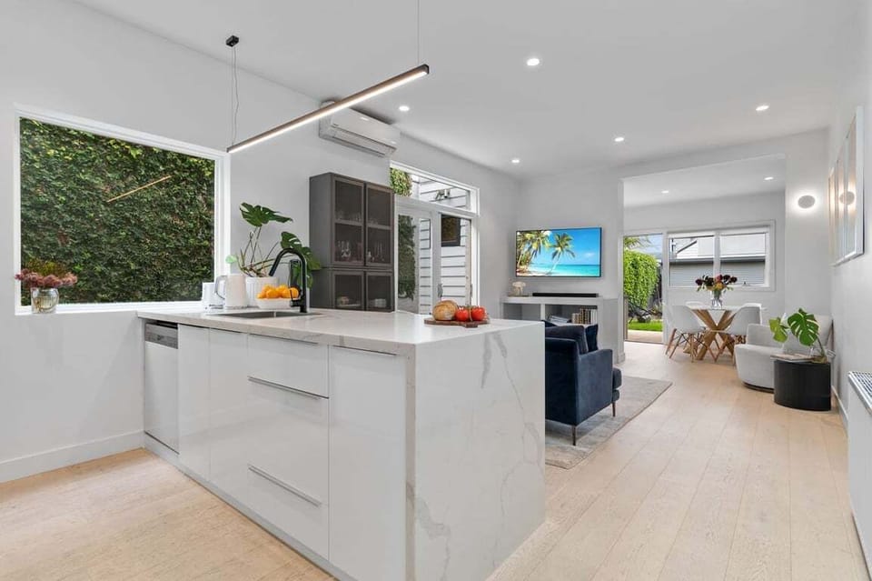 OPEN PLAN: The hall opens to a light and bright open plan kitchen, lounge and dining areas.