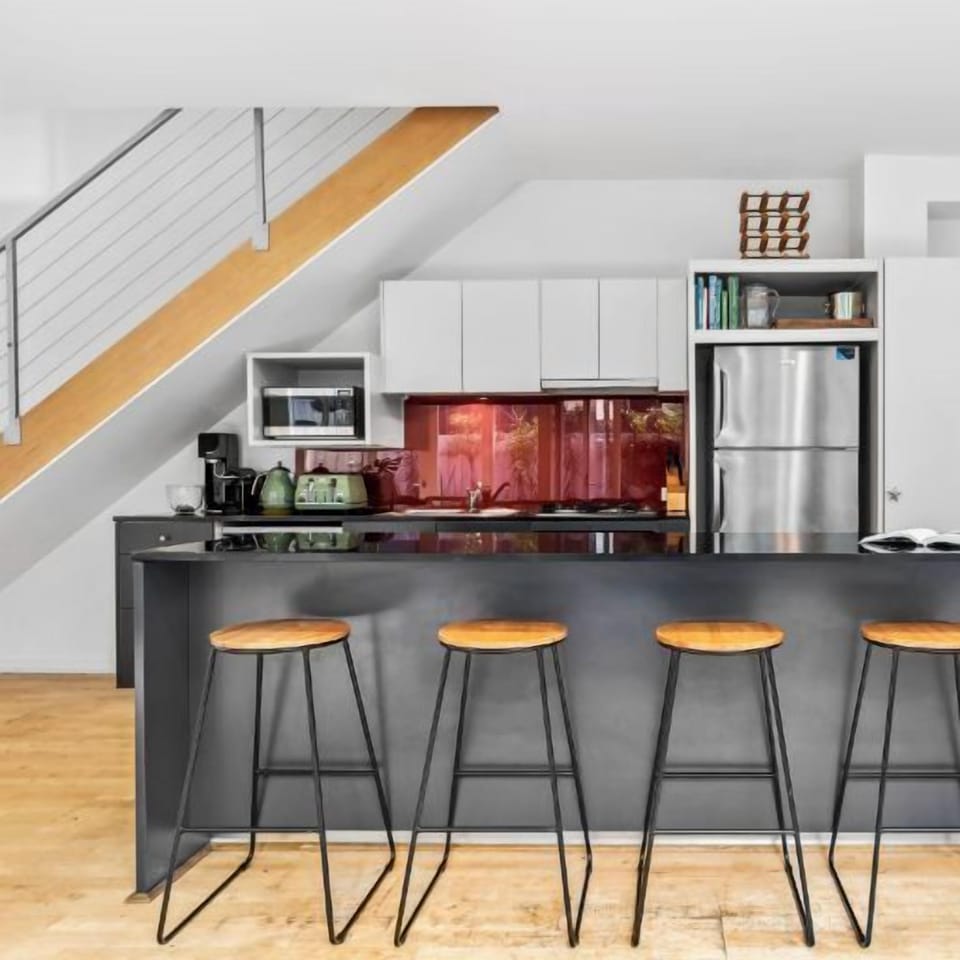 KITCHEN: Spacious kitchen with large stone bench top has all the needed appliances. With five stools it is perfect for entertaining or a quick bench top breakfast.