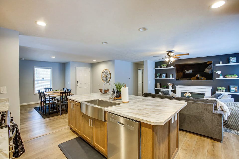 The spacious kitchen has an oversized island with additional seating, dishwashwer, gas stove, microwave, full-sized refrigerator, and all the cookware and dinnerware you will need for your stay.