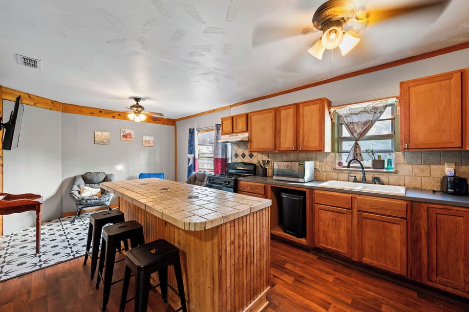 Kitchen fully stocked with utensils, pots pans, oven, stovetop, K cup coffee