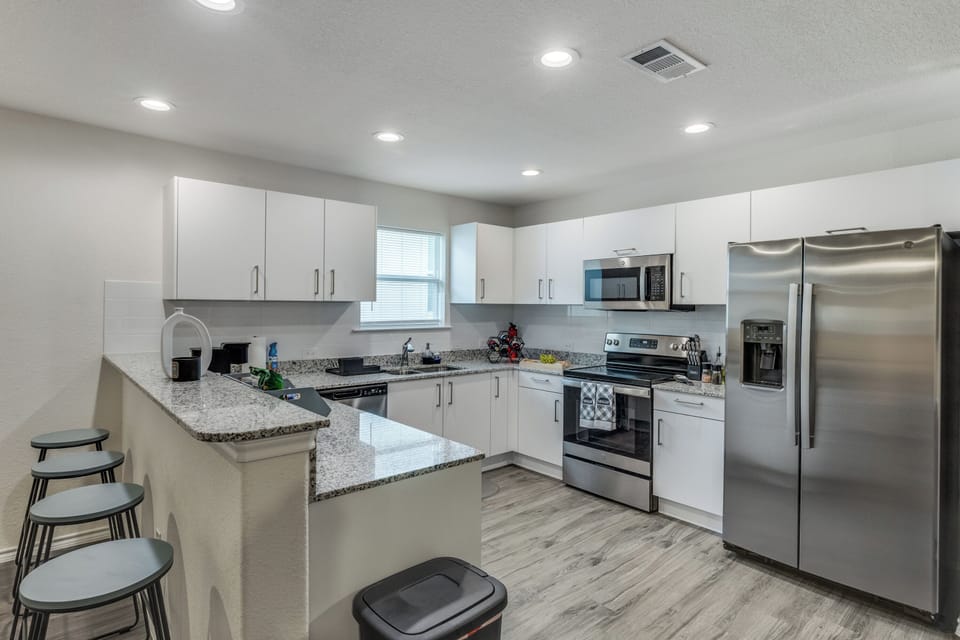 The adjoining kitchen is fully fitted with stainless steel appliances