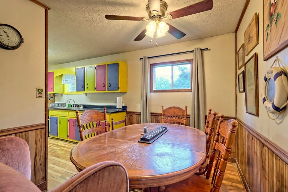 Gather around this cozy dining table for meals and conversations. The open flow to the colorful kitchen creates a warm and inviting space, perfect for family dinners and game nights.