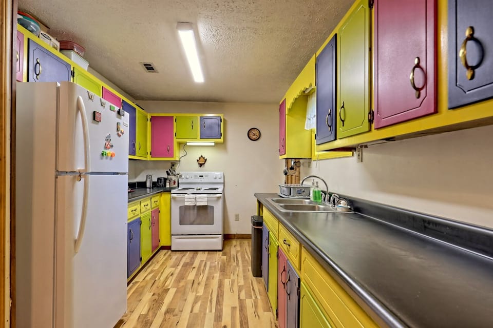 The colorful, retro-style kitchen adds a warm, homey vibe. Enjoy the local produce from Clayton Farmers Market as you prepare meals with a view of the mountains.