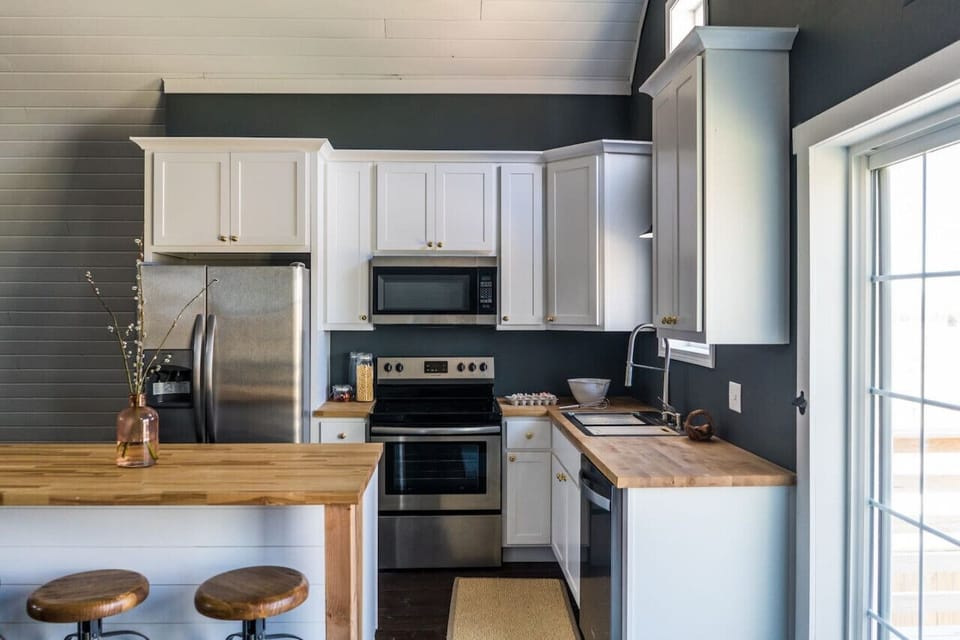 Full kitchen with electric stove and oven.