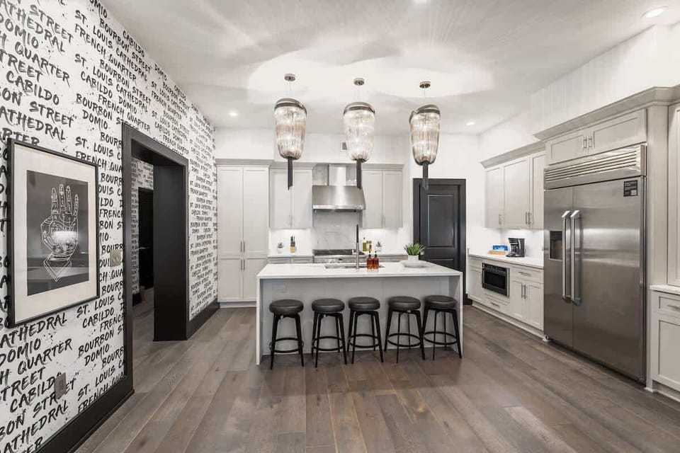 Cook or snack in style with a full kitchen featuring GE stainless appliances, cookware, and an island with bar seating. Ideal for short or extended stays, our kitchens make group travel in New Orleans easy and comfortable.