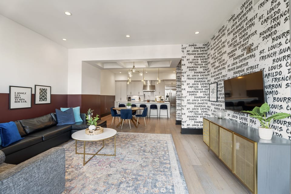 Relax in the living area with a smart TV, stylish seating, and a sleeper sofa for extra guests. Perfect for families or group stays in New Orleans, this inviting space is ideal for movie nights or recharging after a day in the city.