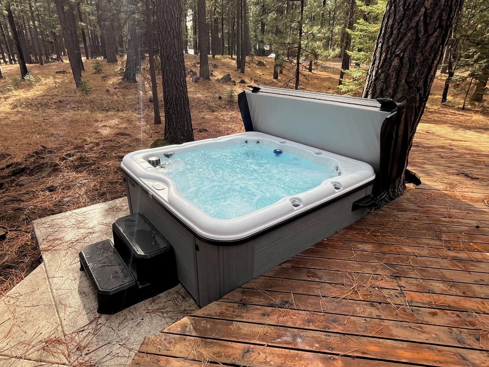 Private hot tub overlooking forested greenspace off of the back deck.  