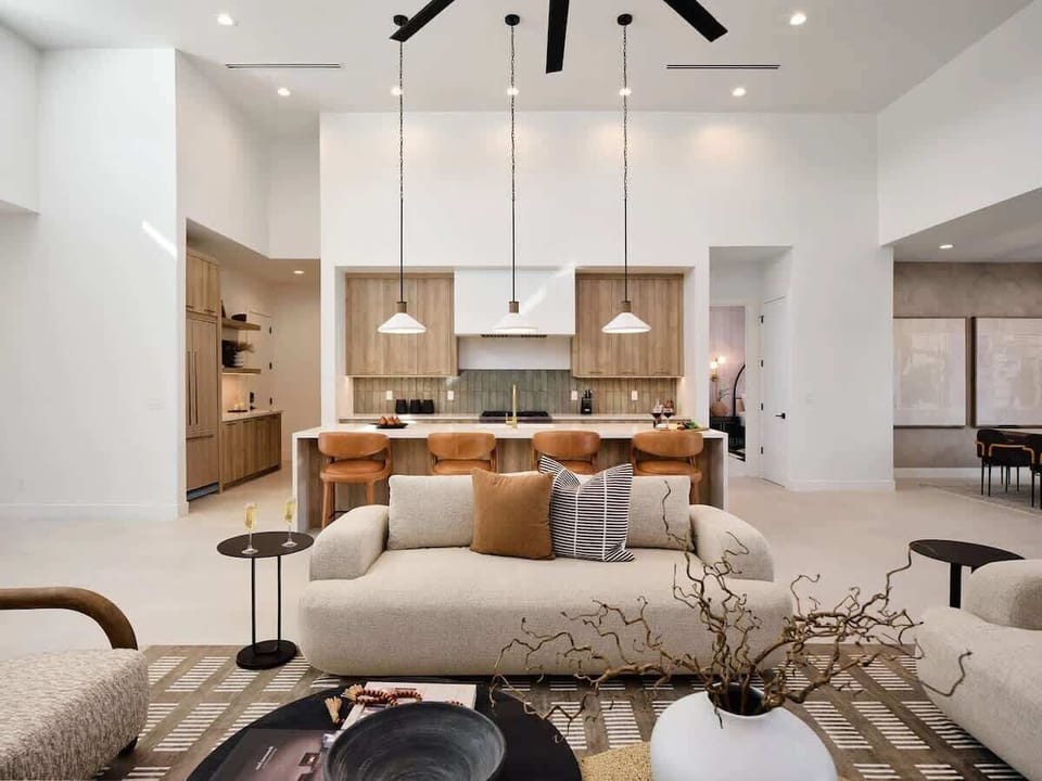 Unit 1: Grand open-concept living space with designer decor, featuring a fireplace and Smart TV.