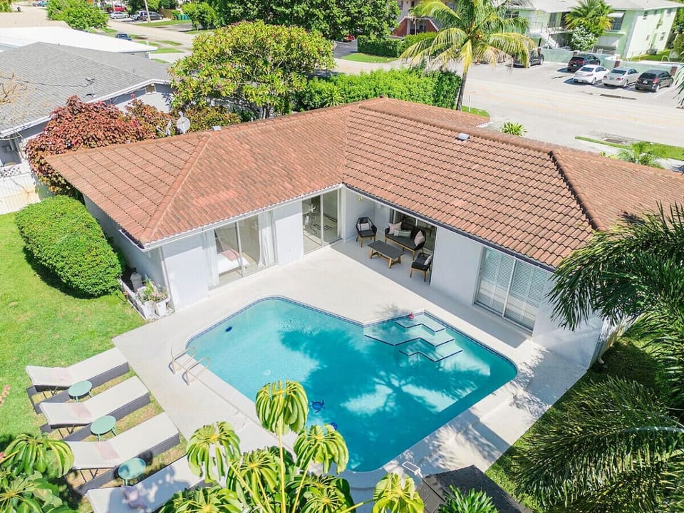 A refreshing pool area set in a landscaped yard, with plenty of space for sunbathing and outdoor gatherings.