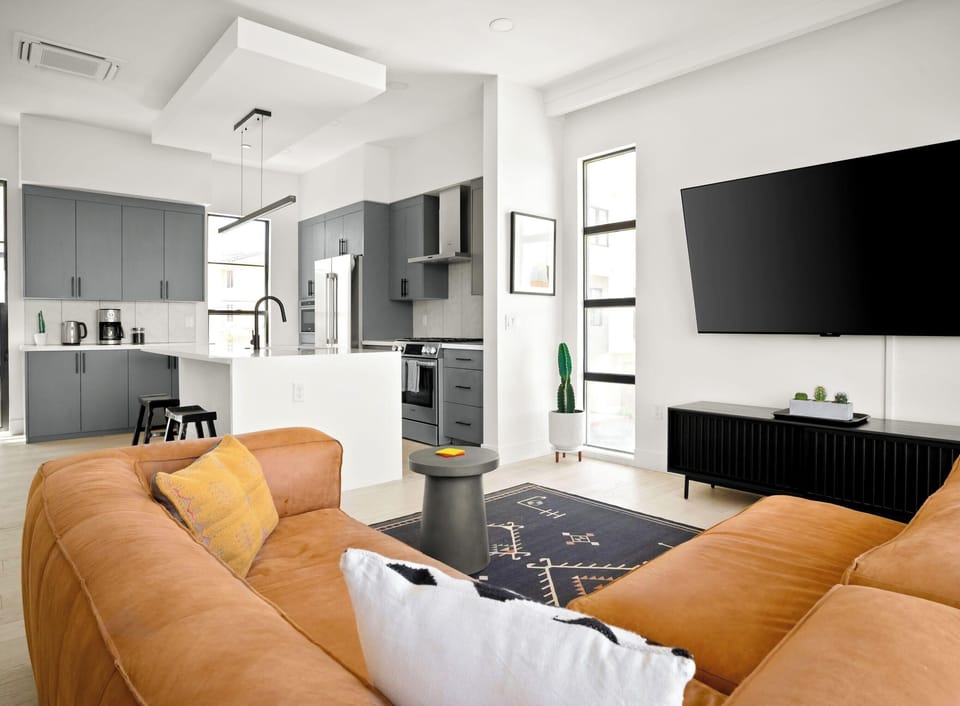 Ultra plush sofa & a large wall-mounted Smart TV for relaxing moments at home.