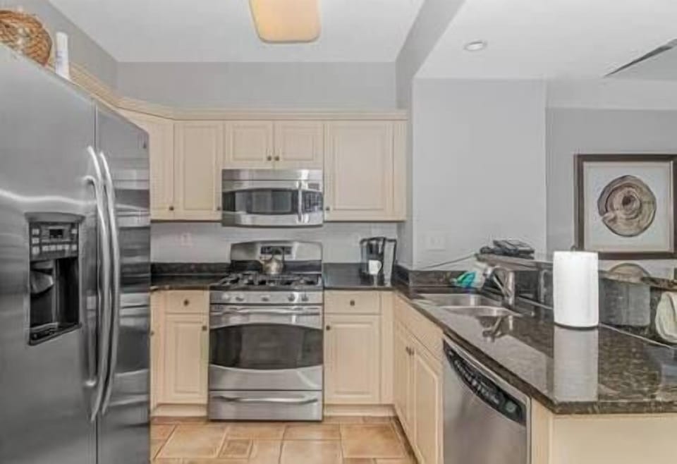Fully stocked kitchen featuring granite countertops and stainless steel appliances