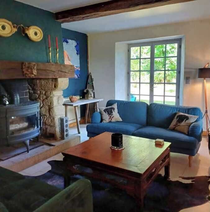 Salon with double doors to terrace and woodburning stove