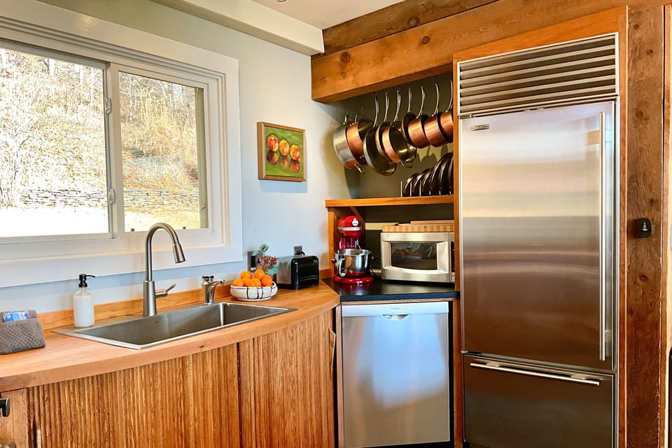 A truly exceptional stay, the kitchen offers a Sub Zero refrigerator, Jenn Air high BTU dual fuel range, Bosch dishwasher, handmade cabinetry, tableware by area potters, Kitchen Aid stand mixer, blender, food processor, cookware & bakeware.