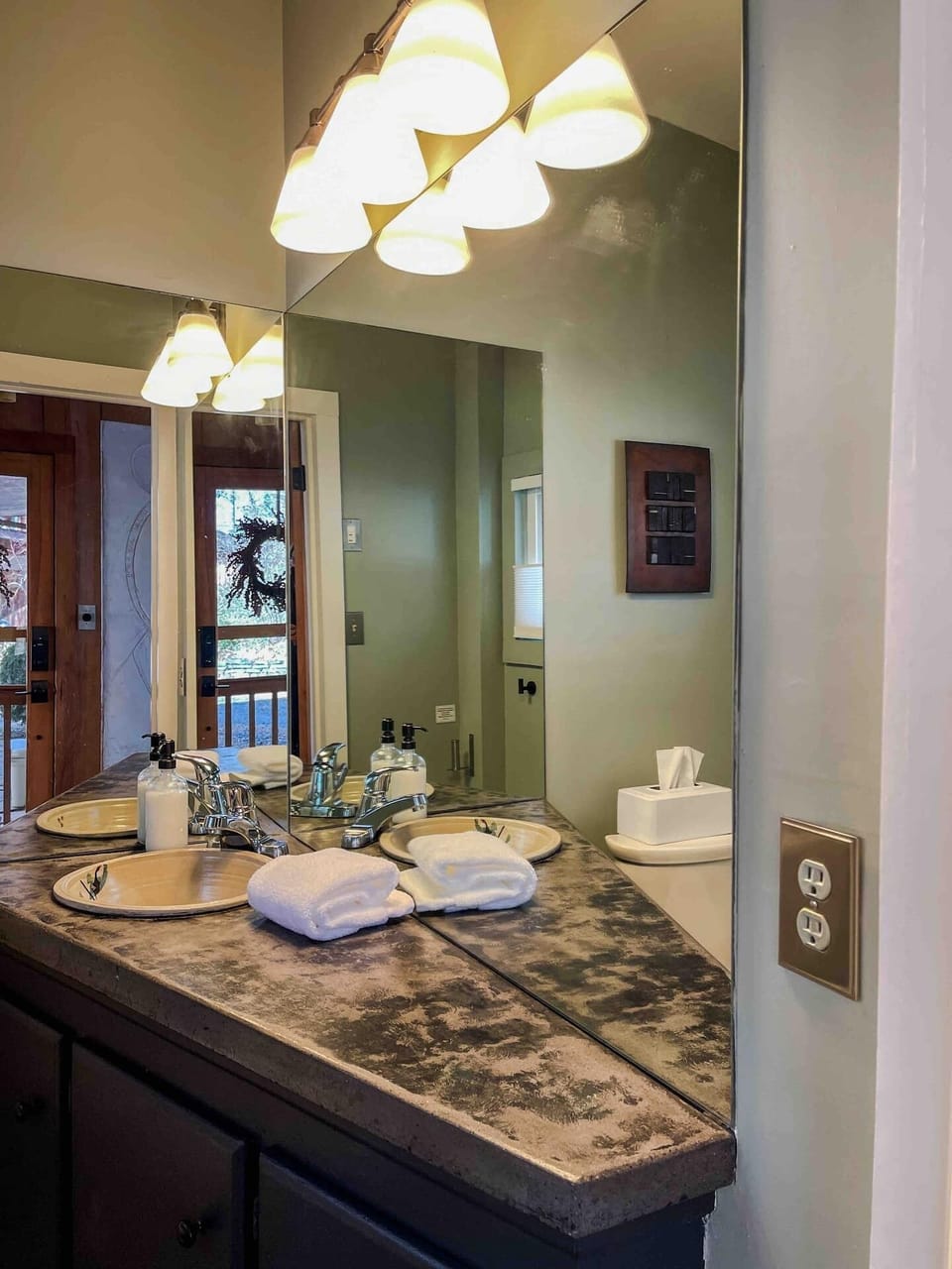 The half bath is at the back of the house for easy access from the studio.