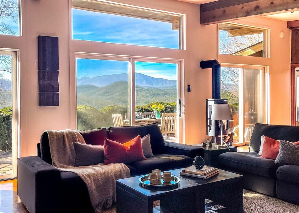 The living room has stunning views of Mt Mitchell and because the house was built passive solar it warm, cozy, or breezy and cool often without the heat or air on. Large sliding doors open to a private patio with grill, herb garden,  and fire pit.