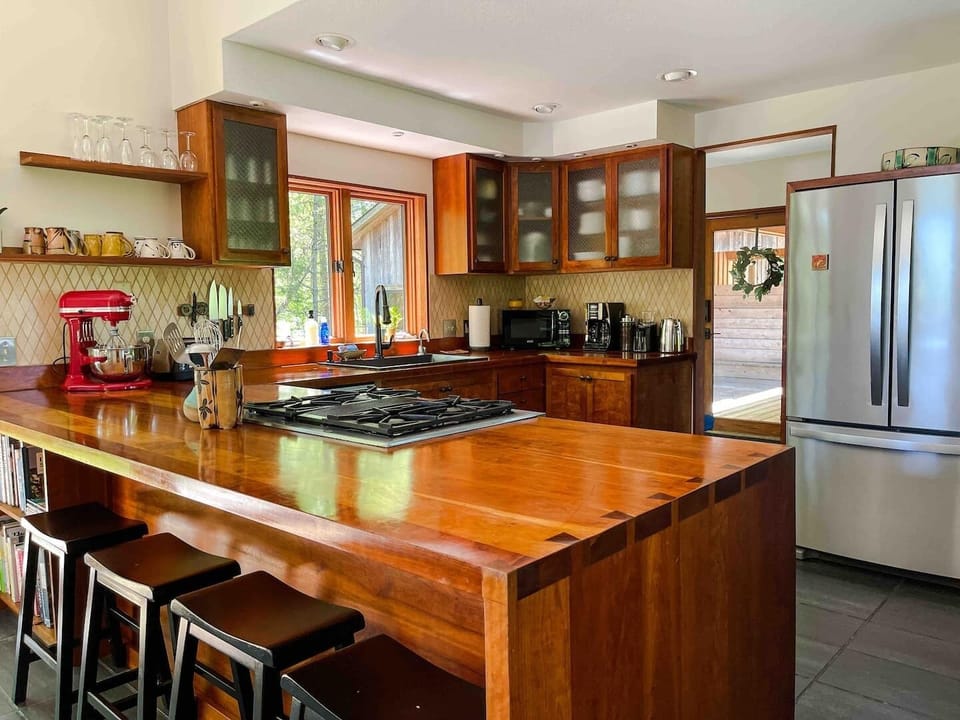 You’ll have almost anything you need to cook for a crowd including All Clad cookware, JA Henckels knives, stand mixer, dual fuel range with convection, blender, food processor, cookbooks, & lots of coffee options and an on-demand hot water dispenser!