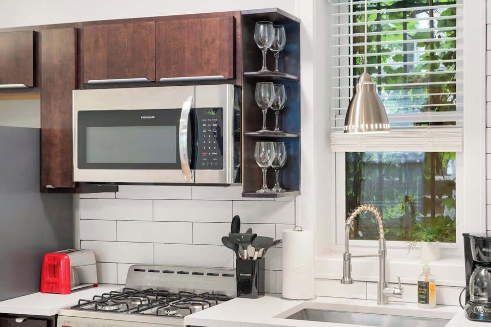 Compact kitchen corner w/ stainless apps & wood accents.