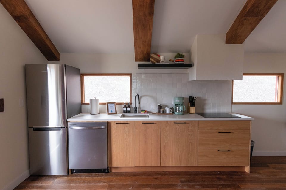Cook and gather in a modern kitchen with sleek finishes and ample natural light.