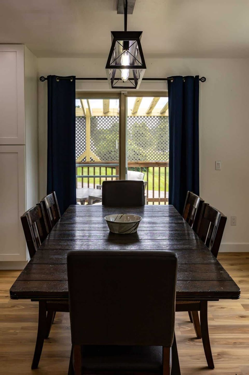"Elegant dining area with views of the outdoor deck."