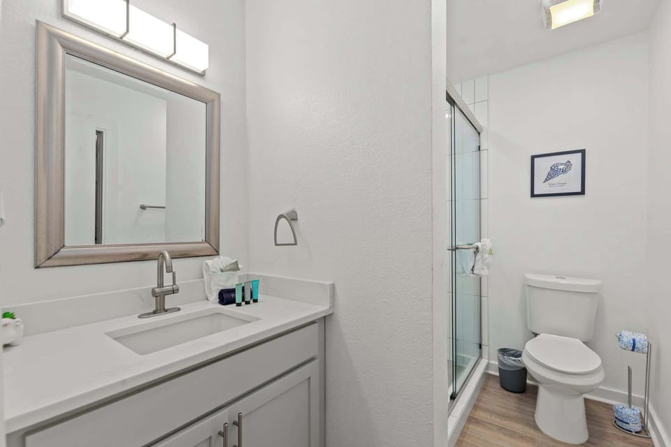 The bathroom features a walk-in shower, plush towels, and plenty of space to get ready.