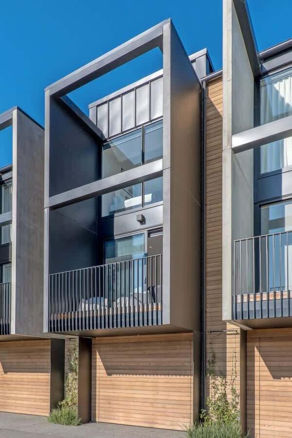 View of the balcony off the living room and the bedroom with two single beds on the top level. Garage on the bottom level.