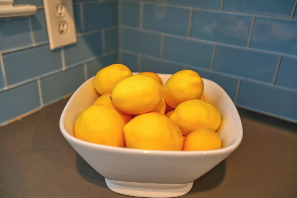 This vibrant fruit bowl adds a pop of color and a touch of local charm to the living room.