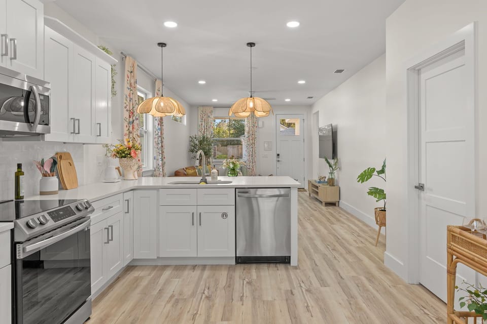 Modern Kitchen: Bright, open space with chic lighting and room to gather.