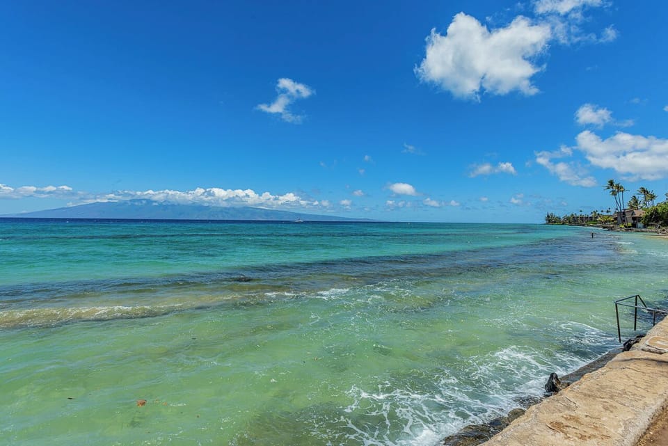 Crystal-clear turquoise waters meet soft sands along this stunning beachfront, where gentle waves and swaying palms set the scene for your ideal tropical escape.