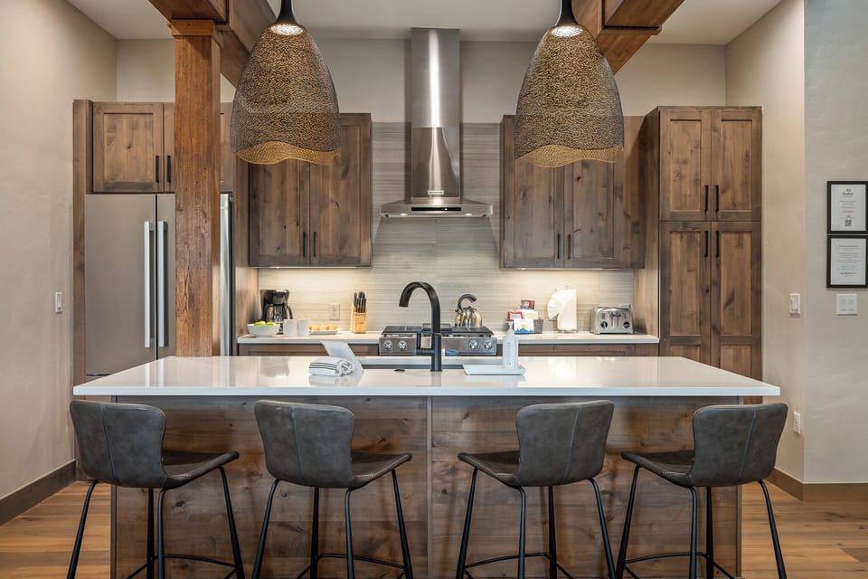- Gourmet kitchen boasts stainless steel appliances and a chef ready gas range - Gather around the wide island with seating for four under statement pendant lighting