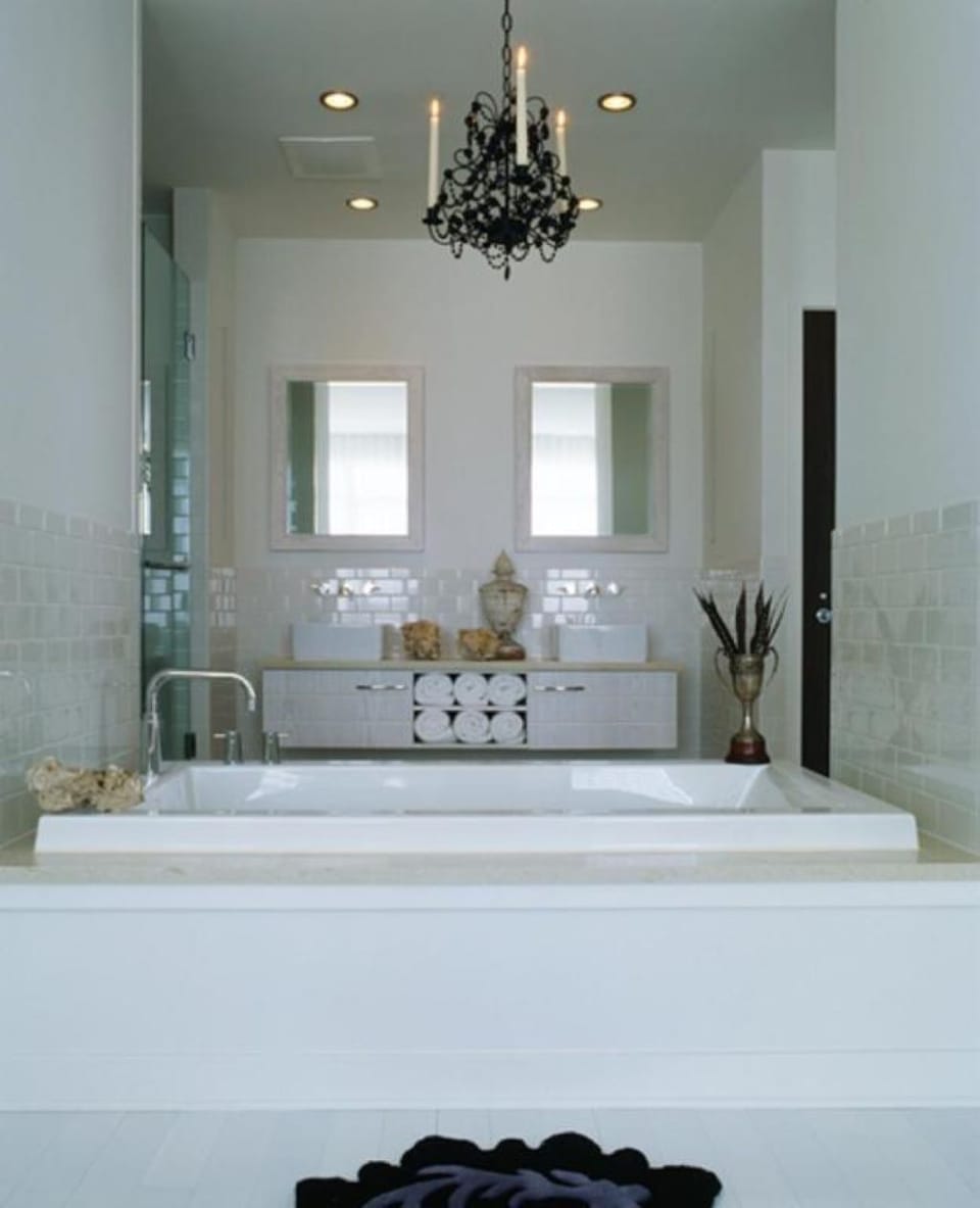 Soak in a deep tub under a glamorous chandelier glow.