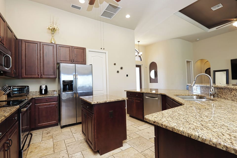 Fully stocked kitchen featuring stainless steel appliances and granite countertops